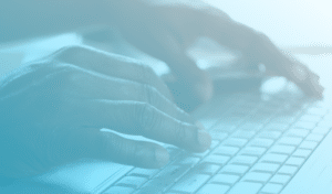 Man's hand typing on a computer