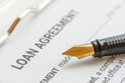 Loan agreement document with fountain pen
