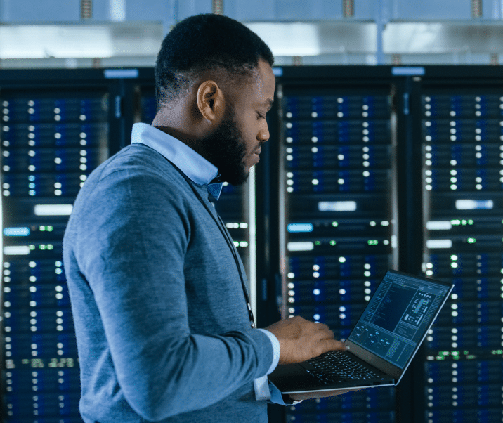 Man in data center with laptop