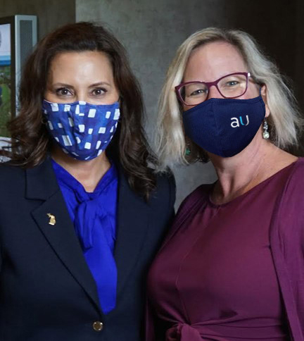 Katie Horvath, CMO of Aunalytics (right), meeting with Michigan's Governor Whitmer at a Michigan Women's Commission event in 2021.